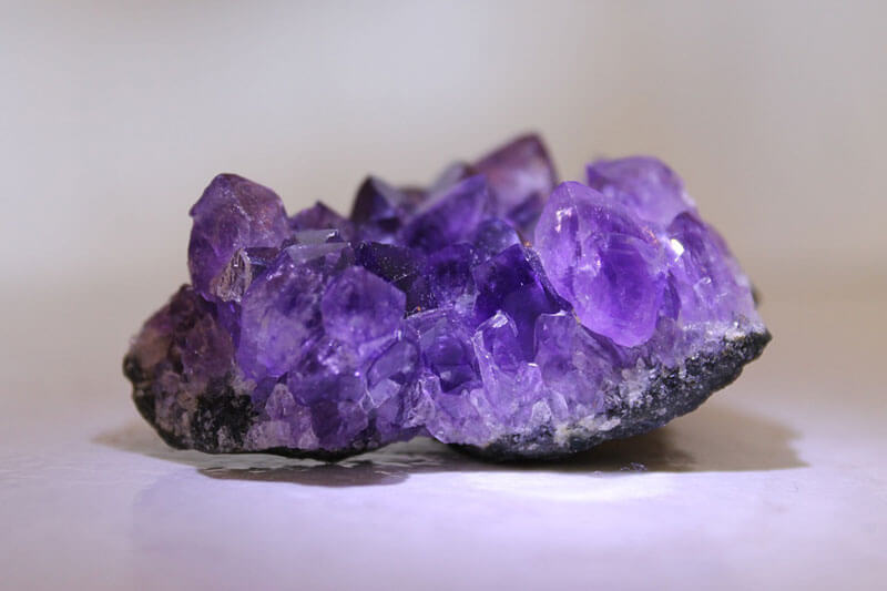 Amethyst geode sitting on table.