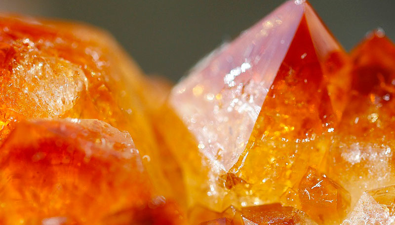 closeup of citrine crystal against green background