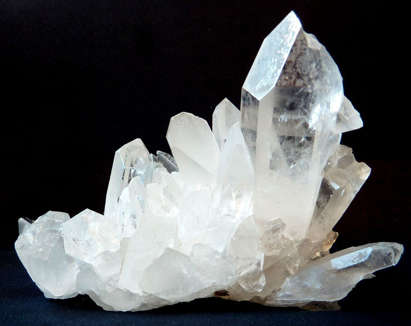 closeup of clear quartz crystal against black background