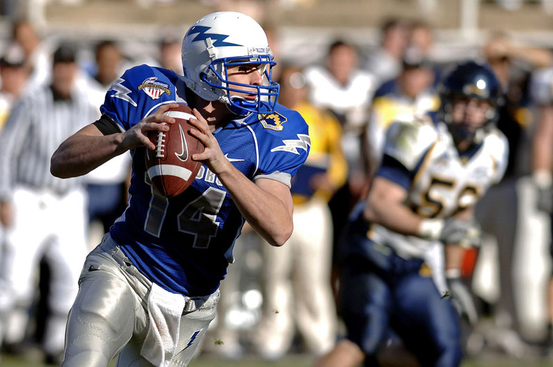 Quarterback about to throw a football during a game.